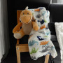 Peluche dinosaure orange et son plaid